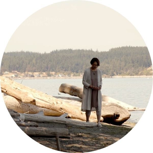 image of Donna Watson walking along the beach
