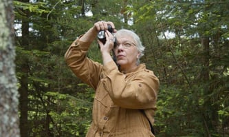 Karen Olson taking photos in the forest