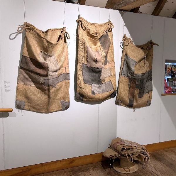 Nicky Ilsley exhibition - The canary and the parrot - hanging sacks